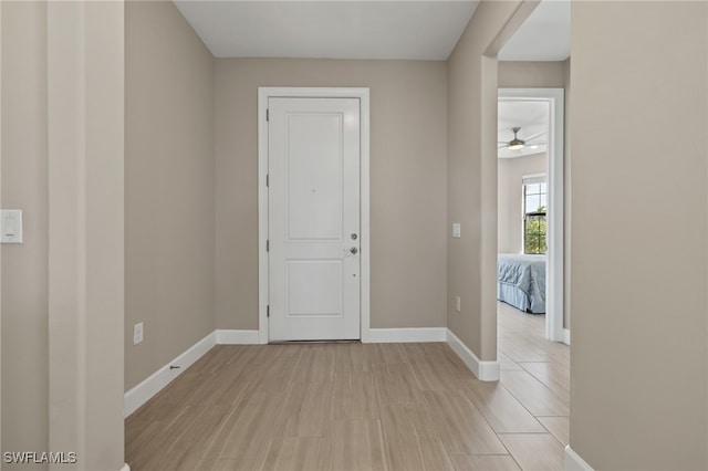 interior space featuring light wood-type flooring and baseboards