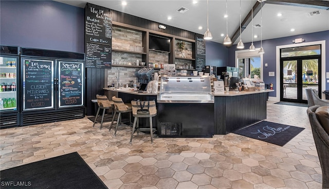 bar featuring hanging light fixtures and french doors