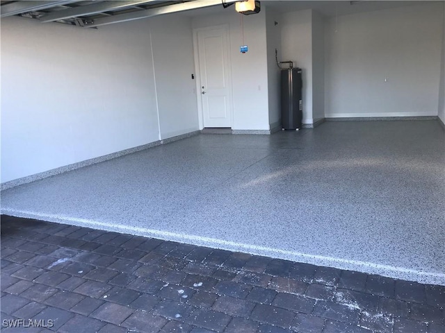 garage with a garage door opener, water heater, and baseboards