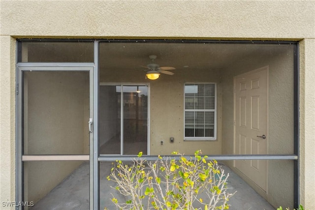 entrance to property with ceiling fan