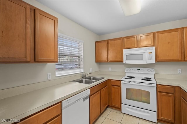 kitchen with a sink, white appliances, light tile patterned flooring, brown cabinetry, and light countertops