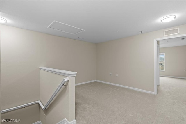 empty room featuring visible vents, carpet flooring, and baseboards