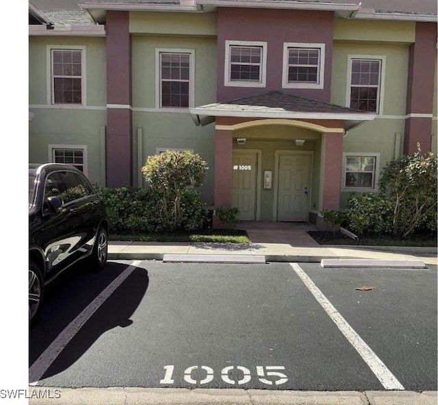 view of front of home featuring uncovered parking and stucco siding