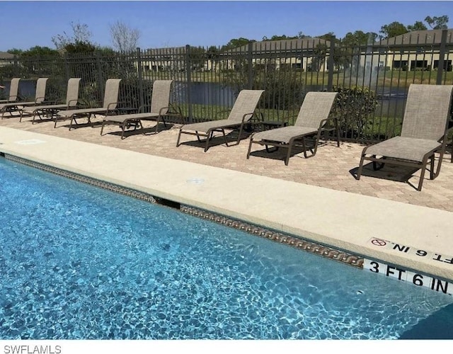 community pool featuring a patio area and fence