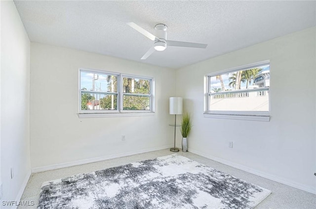 spare room with ceiling fan and a textured ceiling