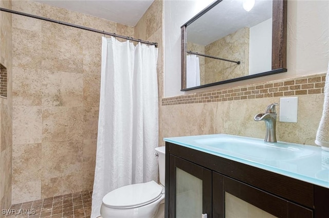 bathroom with toilet, vanity, tile walls, and a shower with curtain