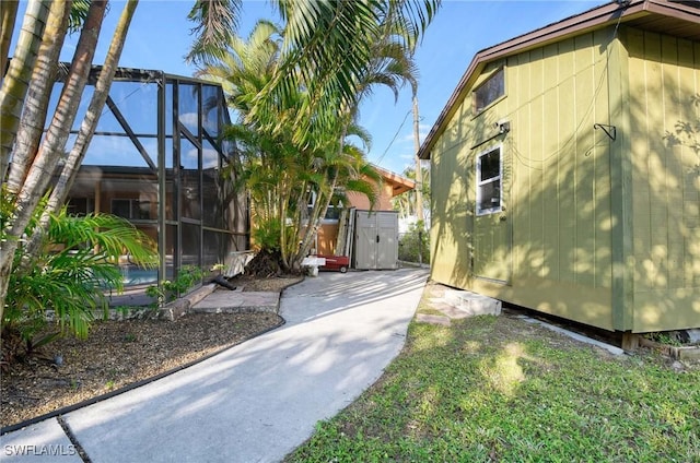 view of side of home with glass enclosure