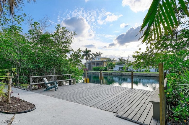 deck with a water view and a dock