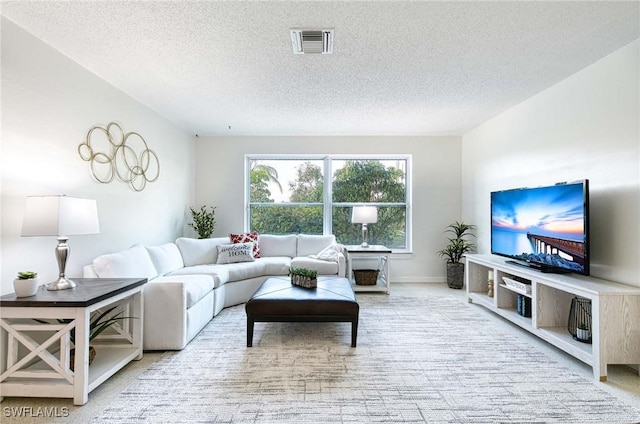 carpeted living room featuring a textured ceiling