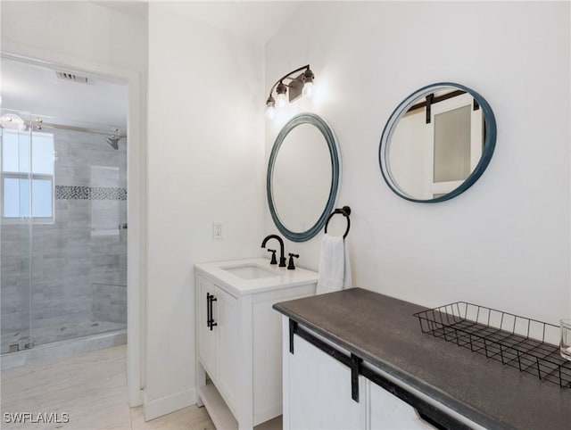 bathroom with vanity and a shower with door