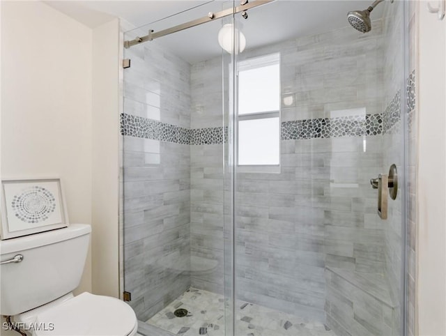 bathroom with an enclosed shower and toilet