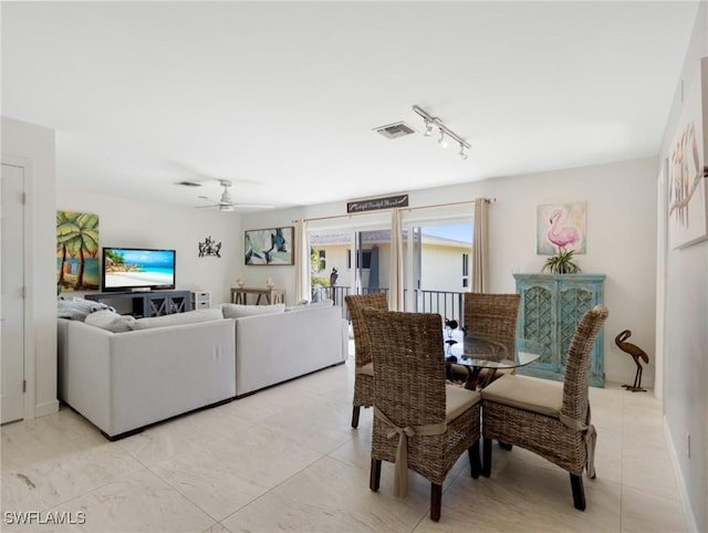 dining area with ceiling fan and light tile patterned flooring