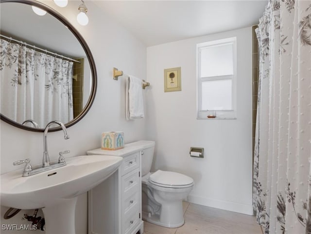 bathroom with sink, a shower with shower curtain, and toilet