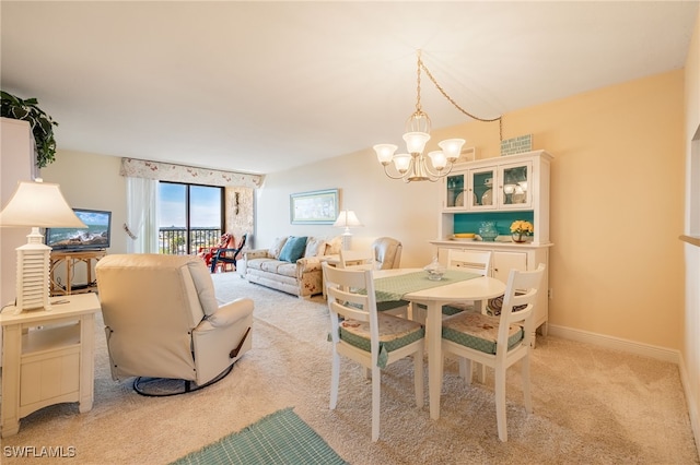 dining space featuring a notable chandelier and light colored carpet