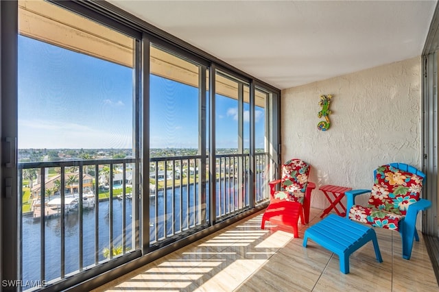 sunroom / solarium featuring a water view