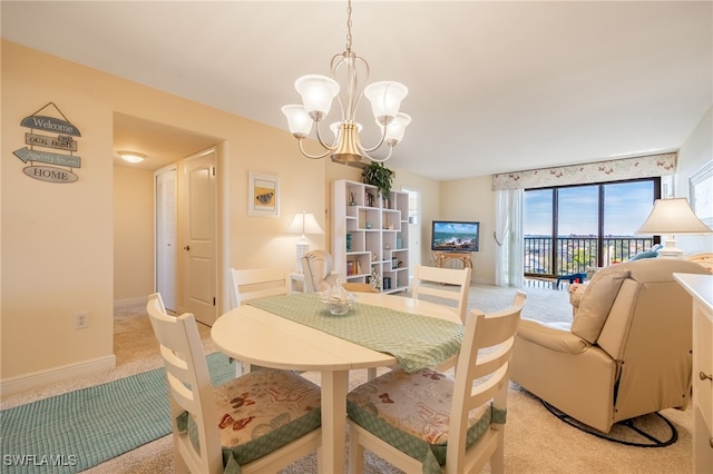 carpeted dining area featuring a chandelier