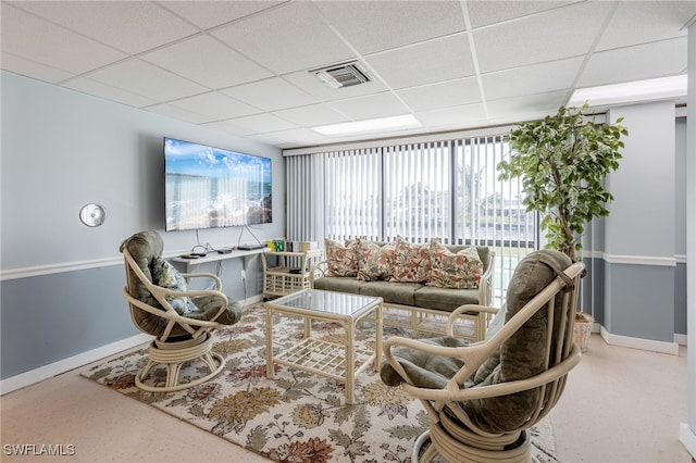 living room with a drop ceiling