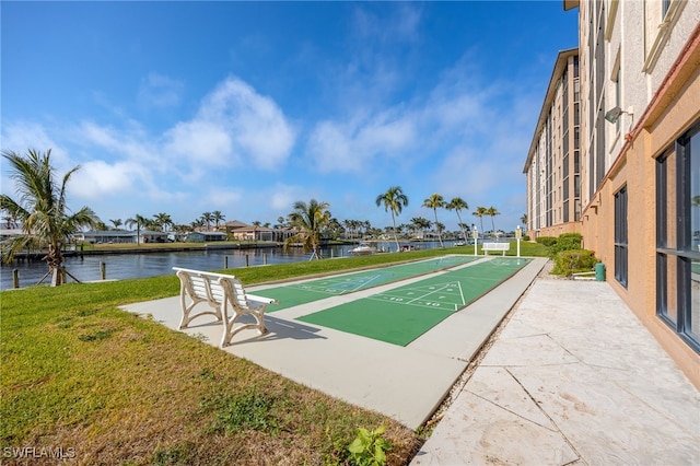 view of home's community featuring a yard and a water view