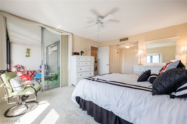 bedroom featuring ceiling fan, carpet floors, and two closets