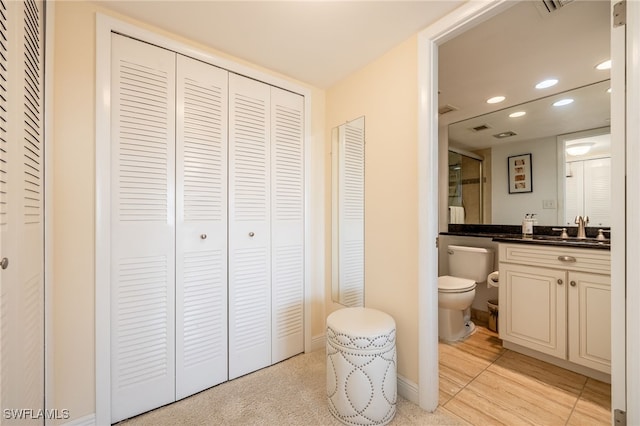 bathroom with vanity and toilet