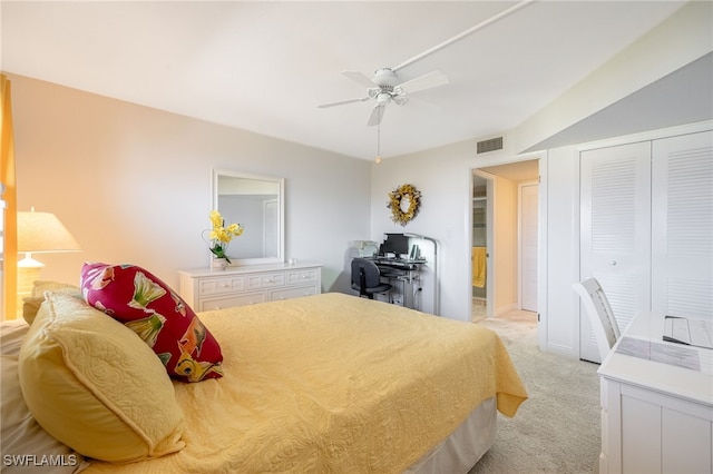 carpeted bedroom with ceiling fan and a closet