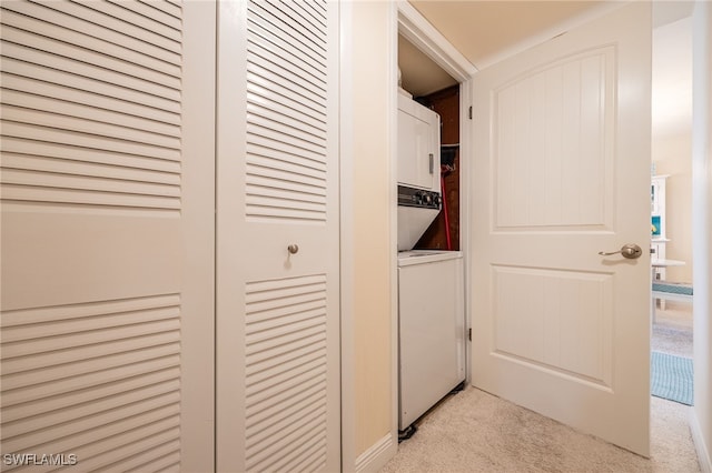 washroom featuring light colored carpet and stacked washer and dryer