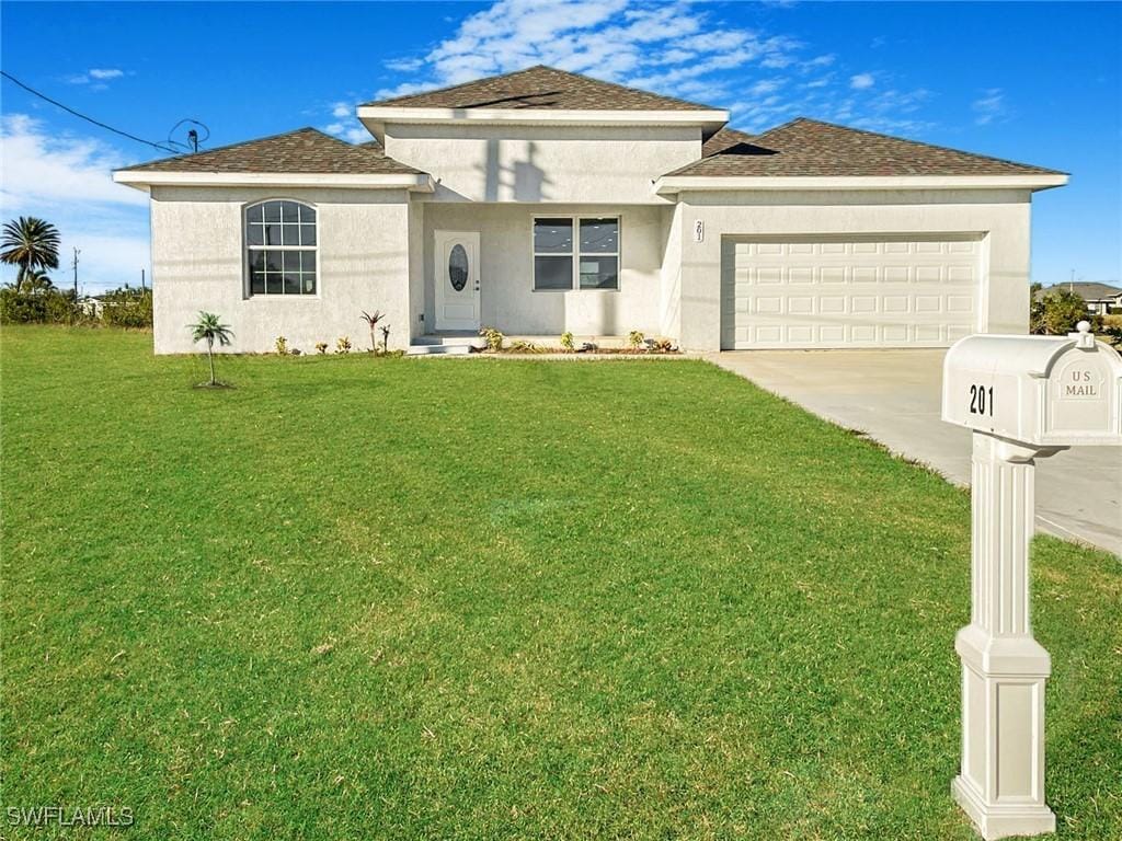 view of front of home featuring a garage and a front lawn