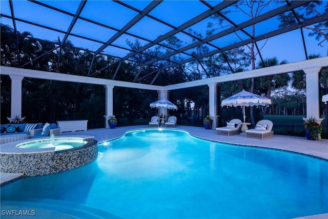 view of swimming pool featuring an in ground hot tub, pool water feature, a patio area, and a lanai