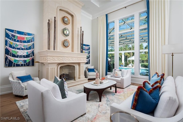 living room featuring hardwood / wood-style flooring, a fireplace, and ornamental molding