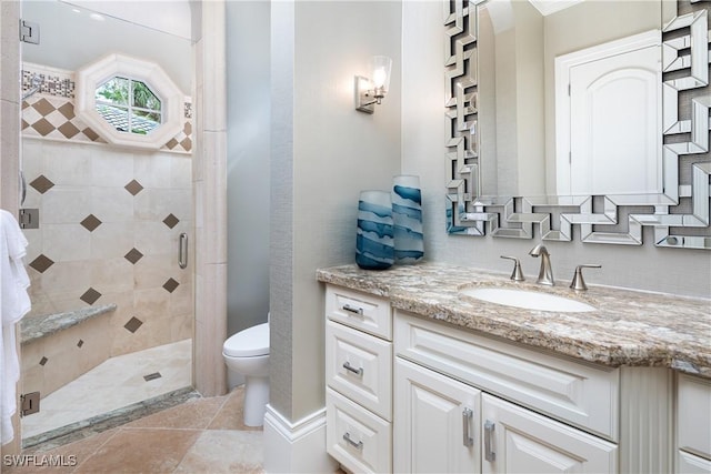 bathroom with vanity, an enclosed shower, and toilet