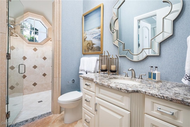 bathroom featuring vanity, toilet, and walk in shower