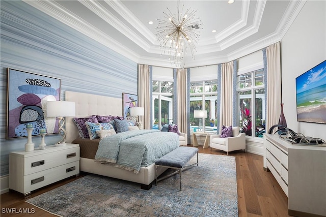 bedroom with a chandelier, a raised ceiling, dark wood-type flooring, and crown molding