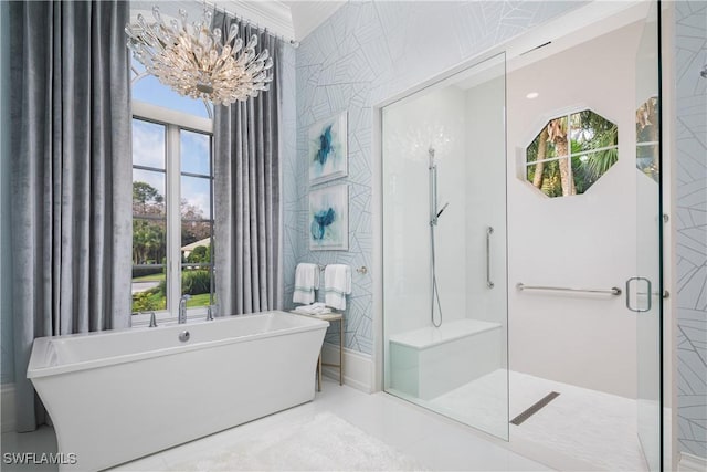 bathroom with shower with separate bathtub and a notable chandelier