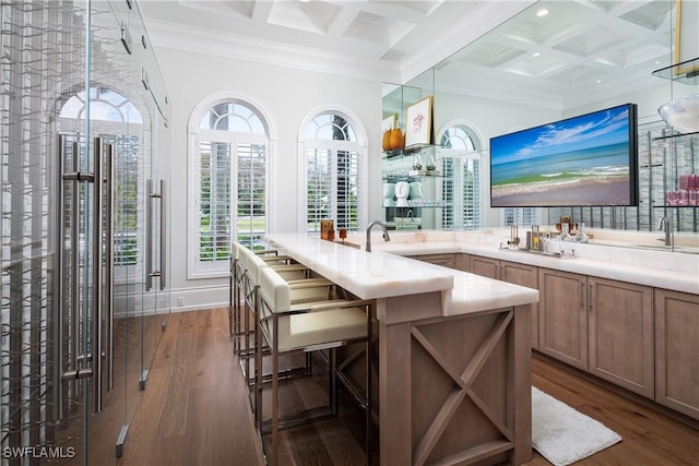 bar with coffered ceiling, dark wood-type flooring, crown molding, beamed ceiling, and hanging light fixtures