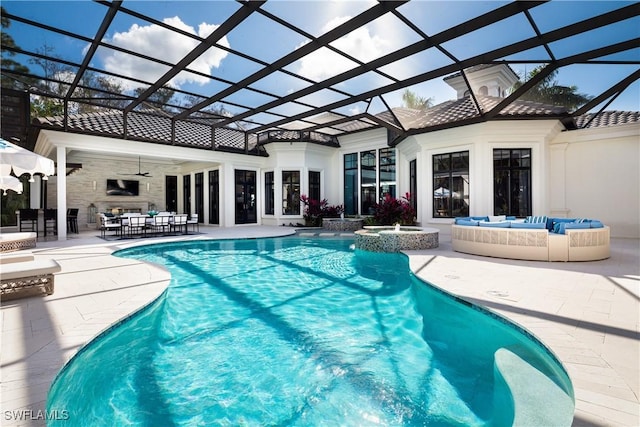 view of swimming pool with a lanai, a patio area, ceiling fan, and outdoor lounge area