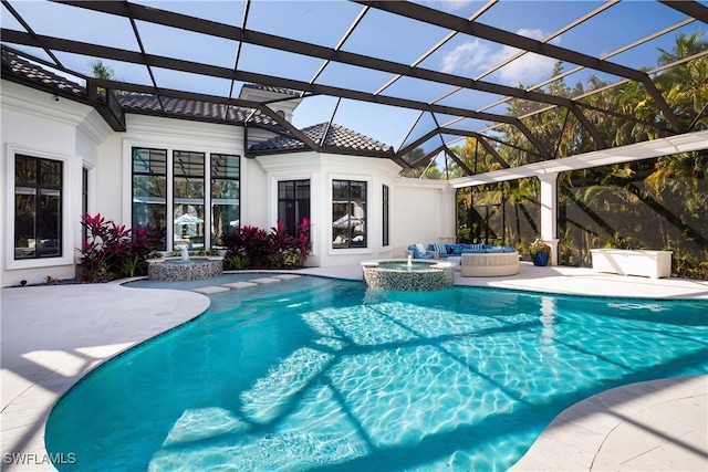 view of pool with a lanai, a patio area, and an in ground hot tub