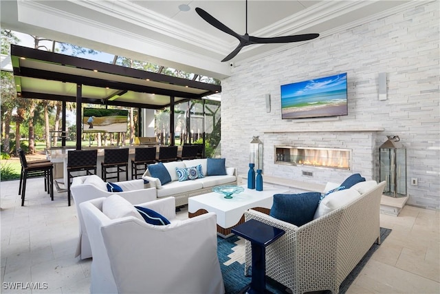 view of patio with an outdoor living space with a fireplace and a bar