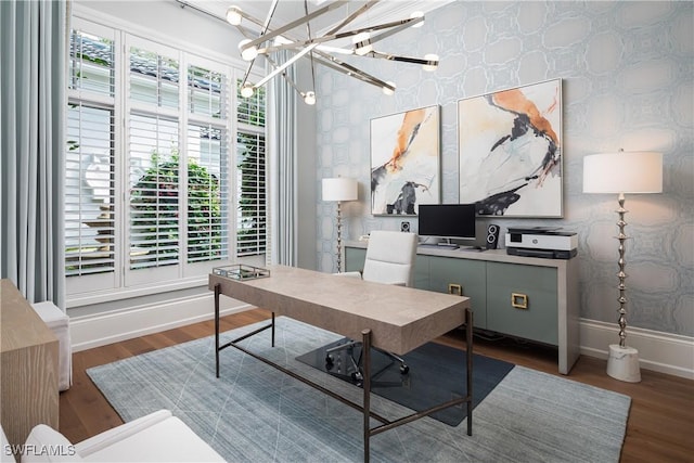 office area with dark hardwood / wood-style flooring and an inviting chandelier