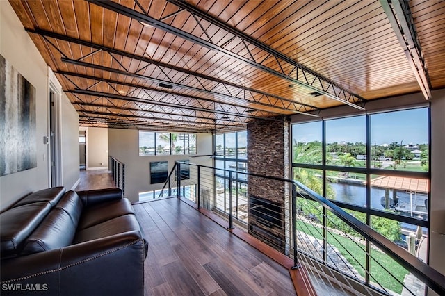 unfurnished sunroom featuring a water view and rail lighting