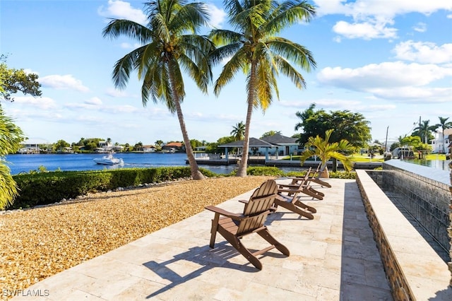 view of property's community featuring a patio area and a water view