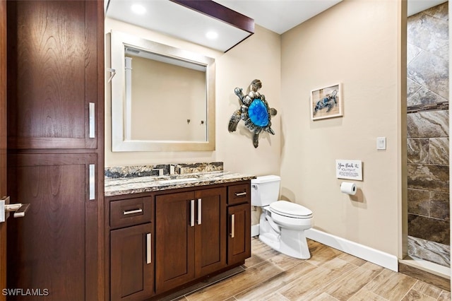 bathroom featuring vanity, toilet, and a shower