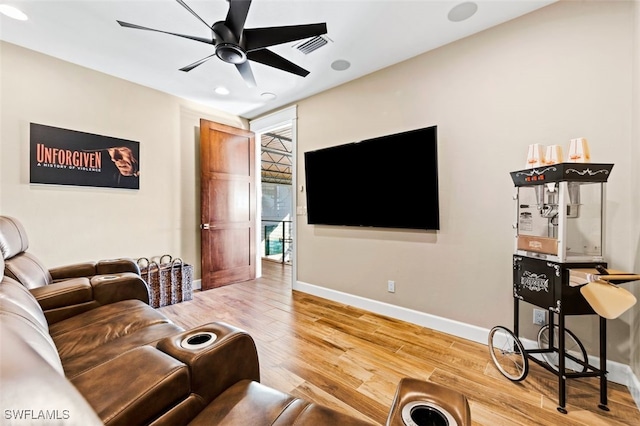 living room with hardwood / wood-style flooring and ceiling fan