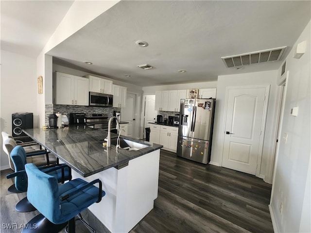 kitchen with white cabinetry, kitchen peninsula, sink, and appliances with stainless steel finishes