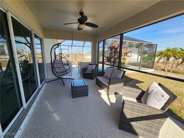 sunroom featuring ceiling fan