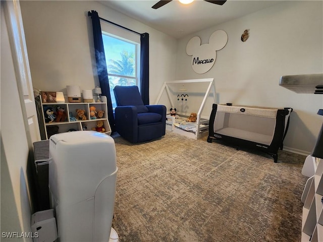 living area with carpet and ceiling fan