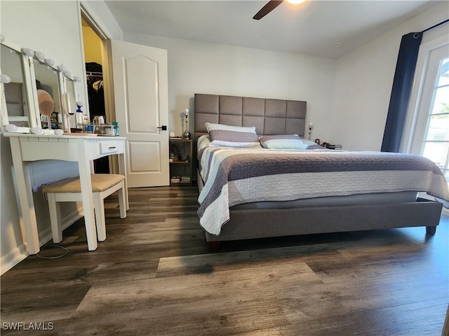 bedroom with ceiling fan and dark hardwood / wood-style floors