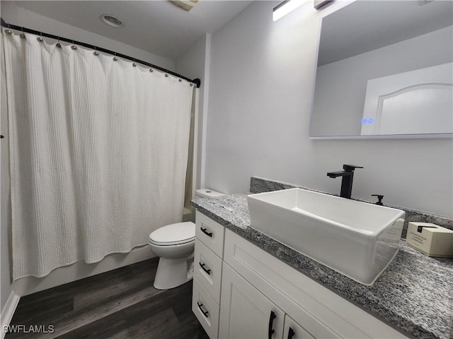 full bathroom featuring wood-type flooring, vanity, toilet, and shower / bath combo