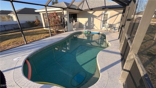 pool with a lanai and a patio area