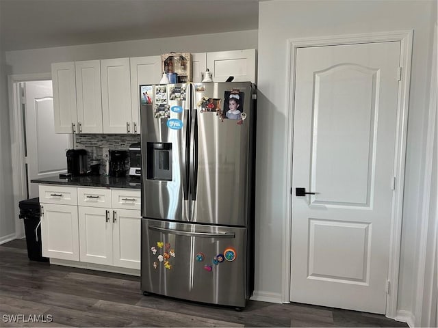 kitchen with decorative backsplash, stainless steel fridge, white cabinetry, and dark hardwood / wood-style floors