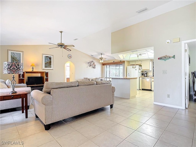 living room featuring ceiling fan, light tile patterned flooring, and vaulted ceiling